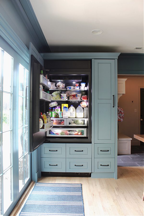 Integrated appliances in our all blue kitchen! Love how the refrigerator looks like cabinets.