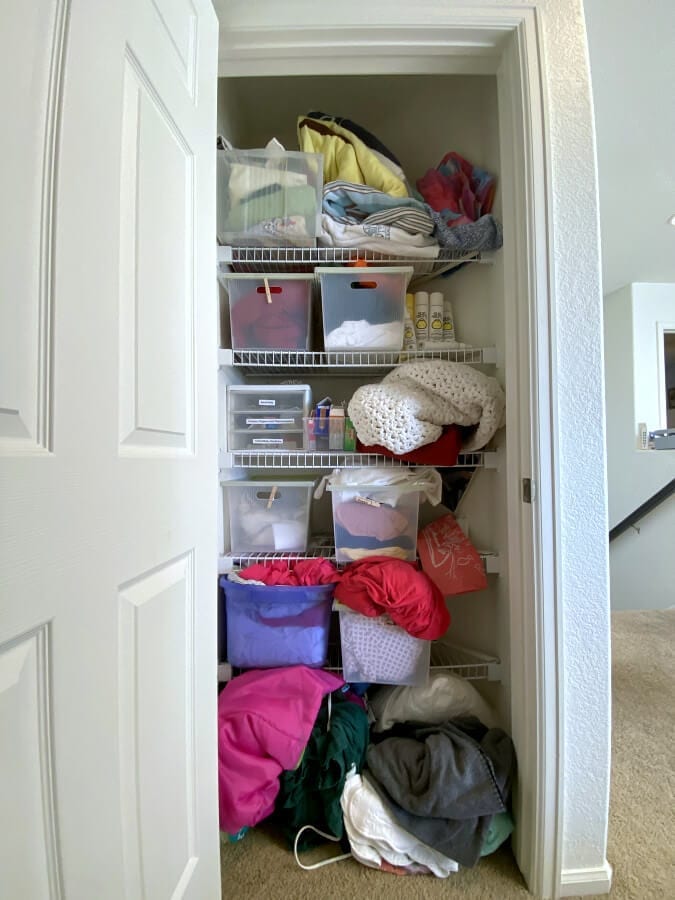 Our linen closet BEFORE the budget friendly makeover.