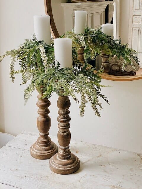 Welcome Home Saturday: Summer Candle Rings Tutorial |Welcome Home Saturday by popular Alabama lifestyle blog, She Gave It A Go: image of two white pillar candles on wooden candle sticks with faux greenery candle rings. 