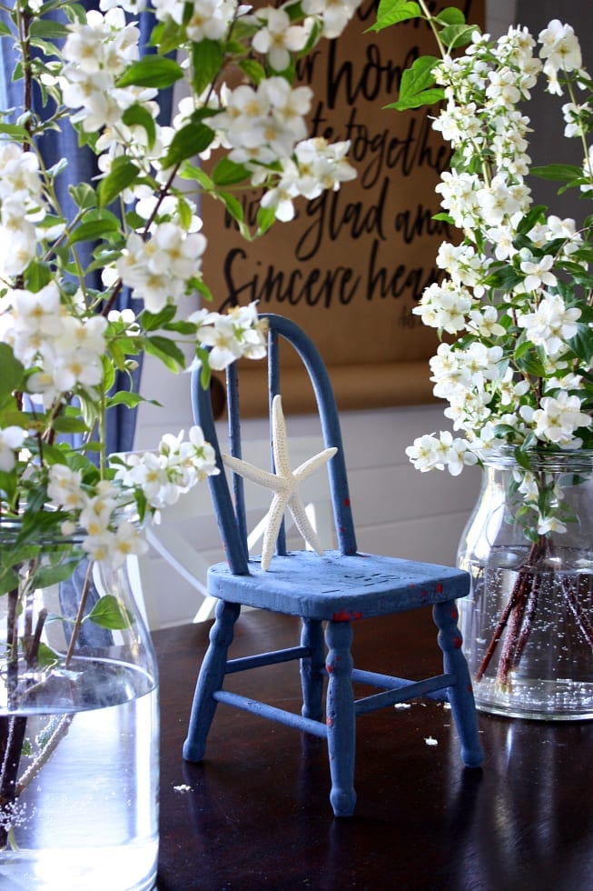 Touches of flowers and painted children's chairs are fun summer decor.