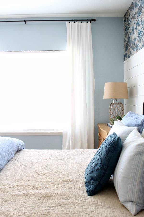 The minute we added these white flowy ceiling height drapes our coastal cottage master bedroom felt complete!