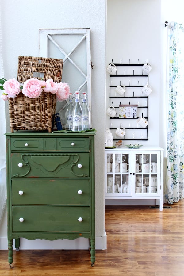 Mugs for days and a green painted dresser give this cottage kitchen a colorful nod to Spring.