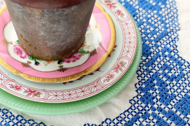 Layered colorful vintage plates are perfect for a Spring cottage kitchen.