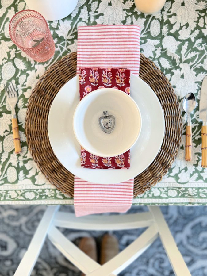 place setting with striped napkin and bowl on plate