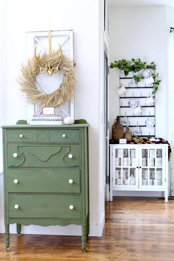 Cozy Fall kitchen decor includes wheat wreaths and green. furniture