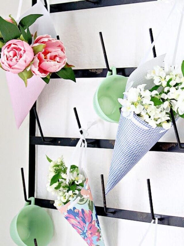 May Day baskets on a mug rack full of flowers.