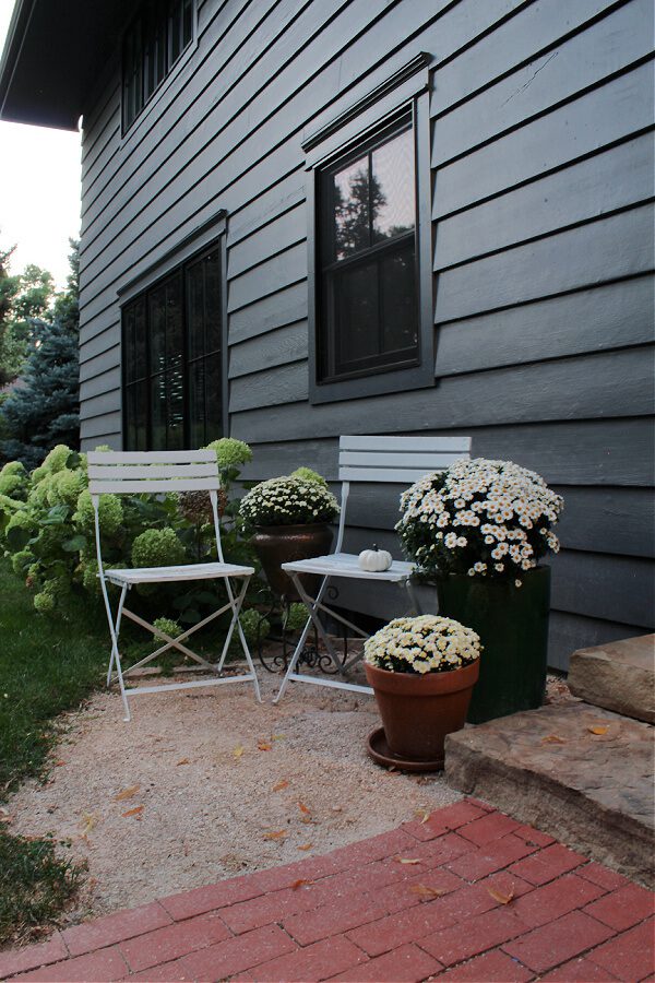 White bistro chairs and mums extend our steps allowing for even more Fall decor in this space.