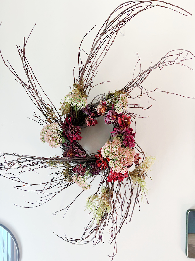 Dried zinnia wreath hung on the wall