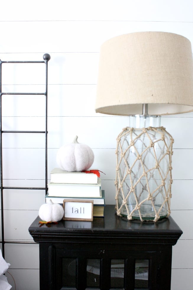 Bedside table  and lamp with some simple Fall decor.