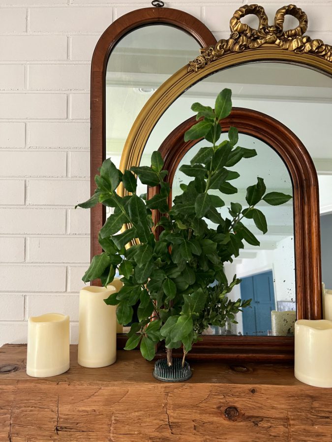 Early fall mantel with greenery, mirrors and candles