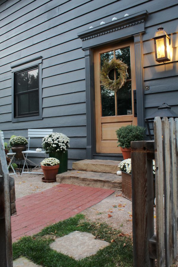 Fall steps with contrasting decor lead to a charming entrance.