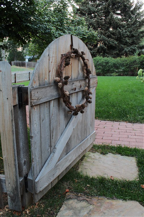 A simple pinecone wreath adds instant charm to our front gate.