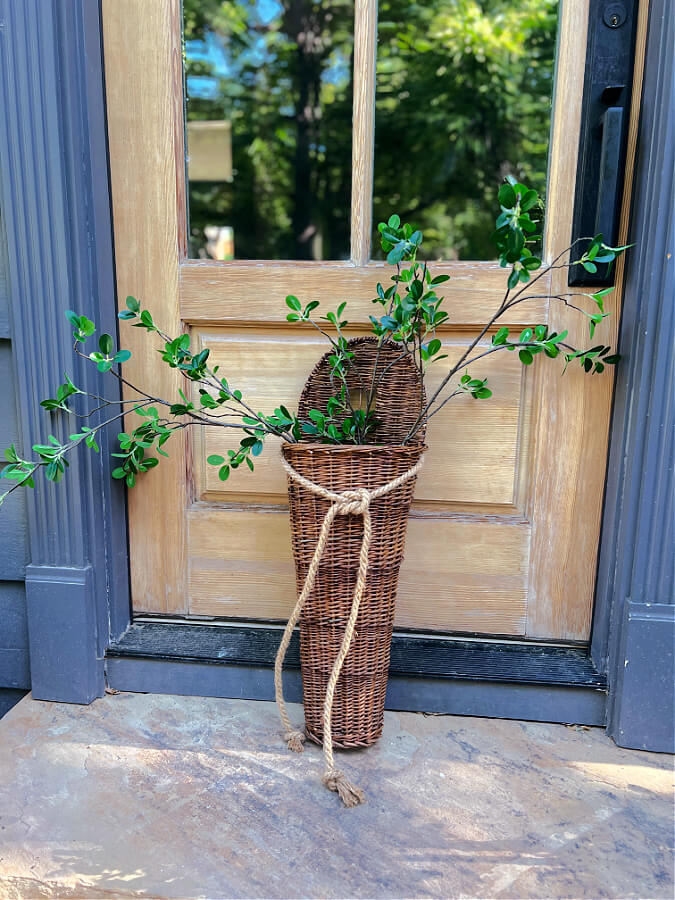 Greenery stems in a hanging door basket