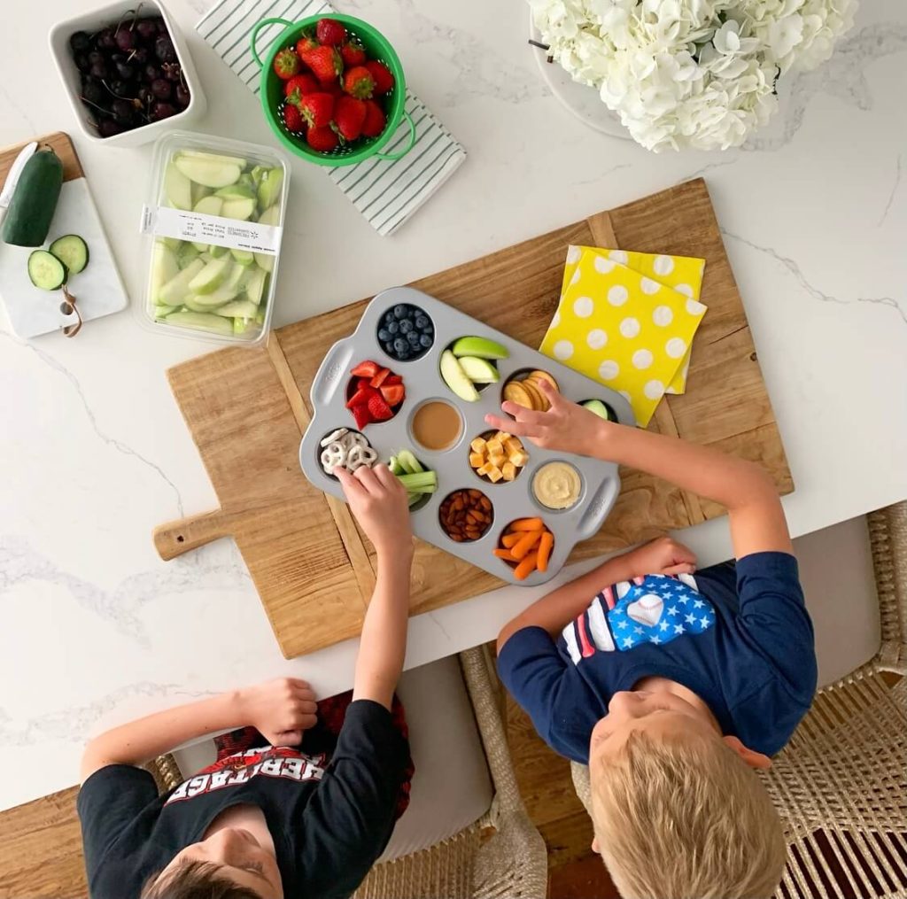 Welcome Home Saturday: Our favorite dummer lunch! | Welcome Home Saturday by popular Alabama lifestyle blog, She Gave It A Go: image of two young boys eating snacks out of a metal muffin tin. 