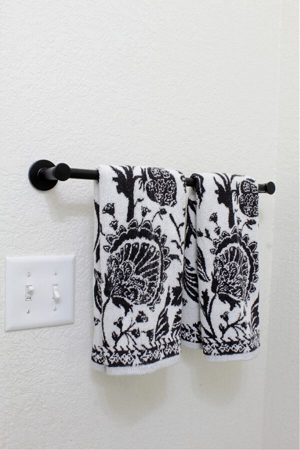 Floral towels and a matted black 18 in towel bar