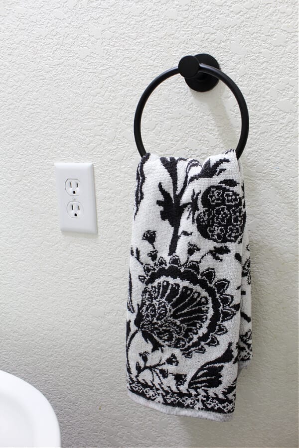 black and white towel and new towel ring