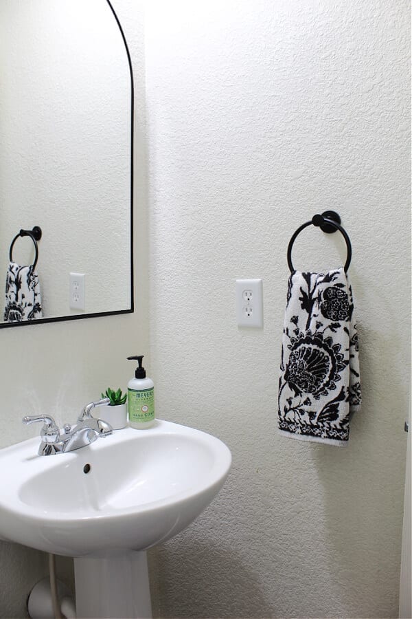 black, white and floral details make this half bath refresh stand out!