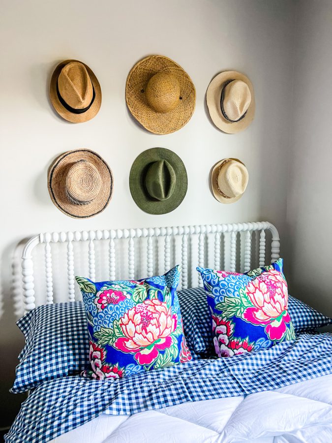 How to display hats on a wall with hooks.