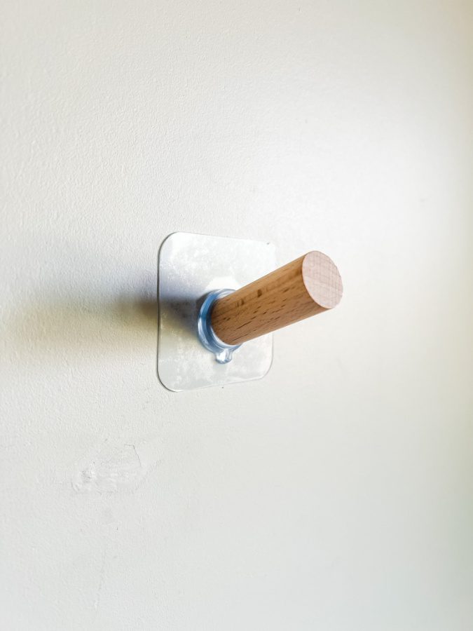 Adhesive wooden wall hook especially for hats.