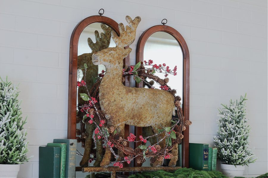 Large rustic metal deer on mantel.