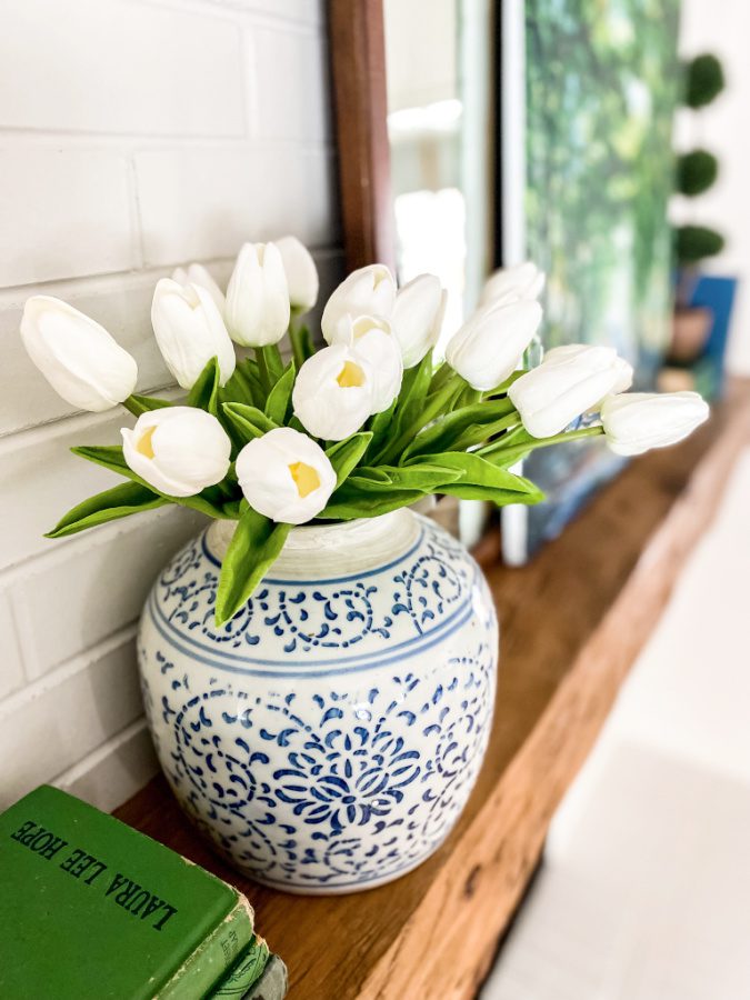 Blue and white ginger jar with tulips on a Spring mantel!
