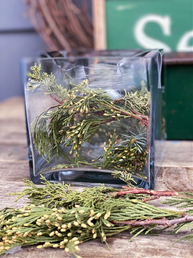 Fill your vase with natural elements like pinecones and greenery.