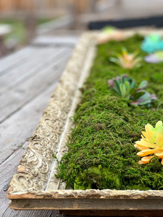 Adding Dollar Store faux succulents to my moss covered pool noodles!