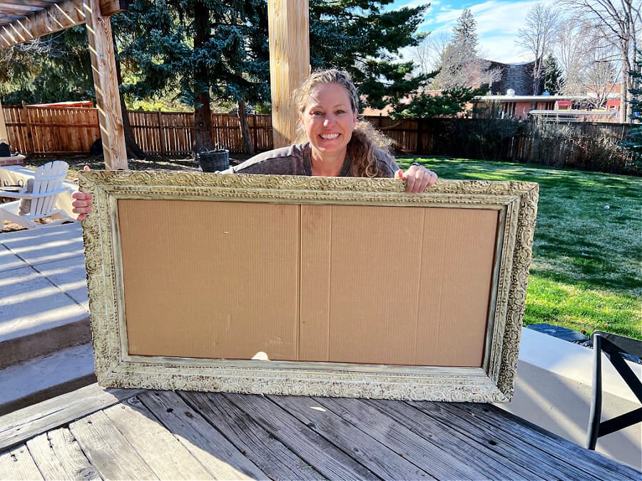 A vintage frame with a cardboard box for a backing.