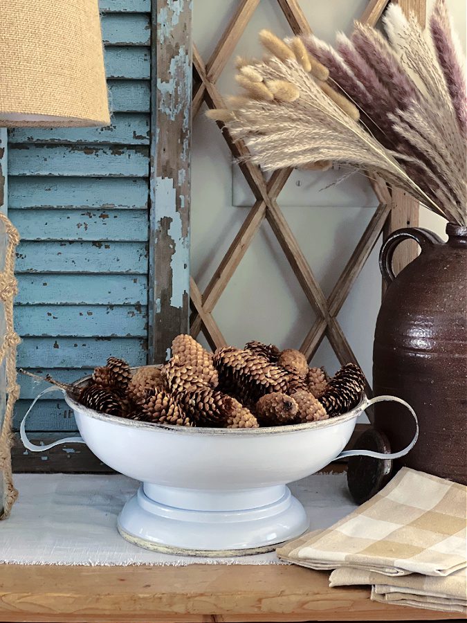 Uins pine cones in my Fall decor in my favorite pedestal bowl.