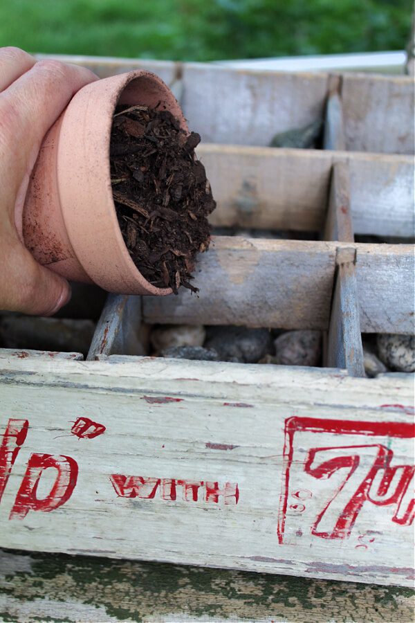 red and white soda crate makes for a budget friendly planter!