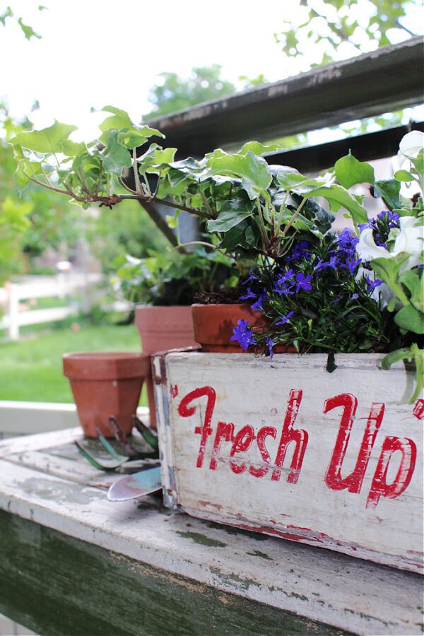 red, white and blue patriotic decor with flowers and a vintage crate.