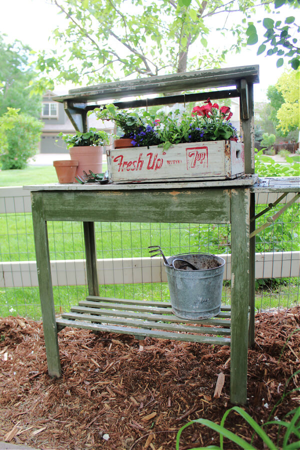 Vintage planter on weathered potting bench