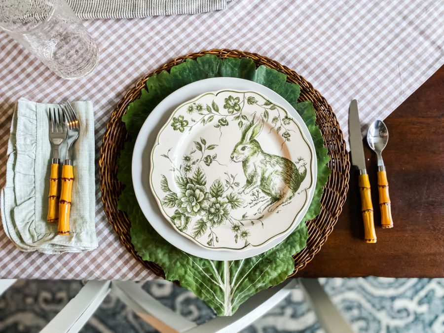 Green and white bunny plates layered on an Easter table.