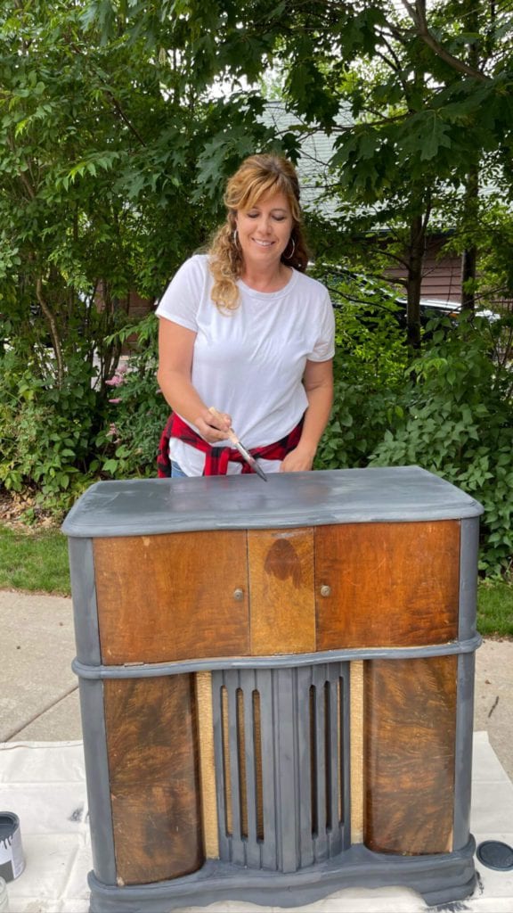 Welcome Home Saturday: Styling My Thrifted Finds | Welcome Home Saturday by popular Alabama lifestyle blog, She Gave It A Go: image of a woman painting a thrifted dresser with grey paint. 