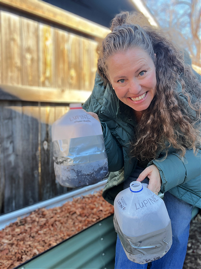me holding winter sowing milk jugs