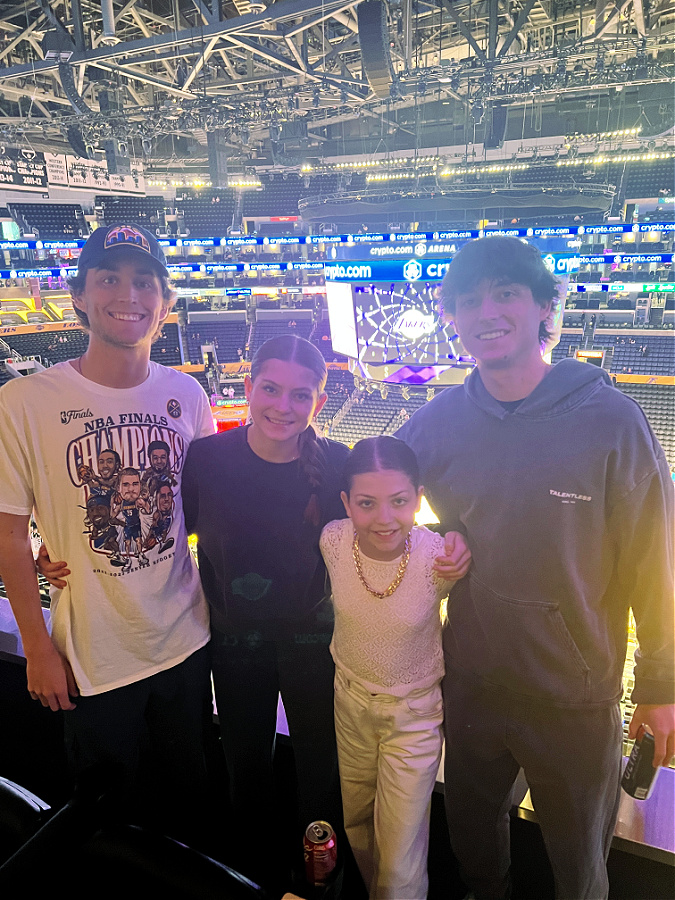 four kids at the Lakers game in the suite