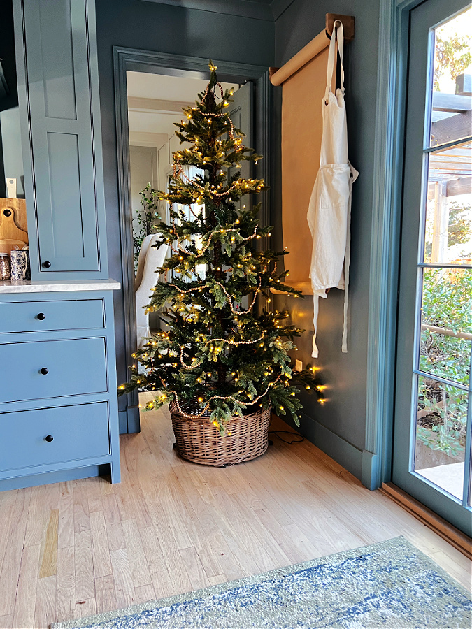Christmas tree in basket in kitchen