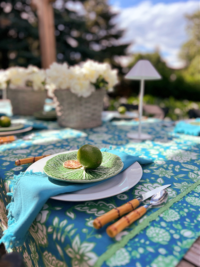 Limes on green plate with bamboo silverware