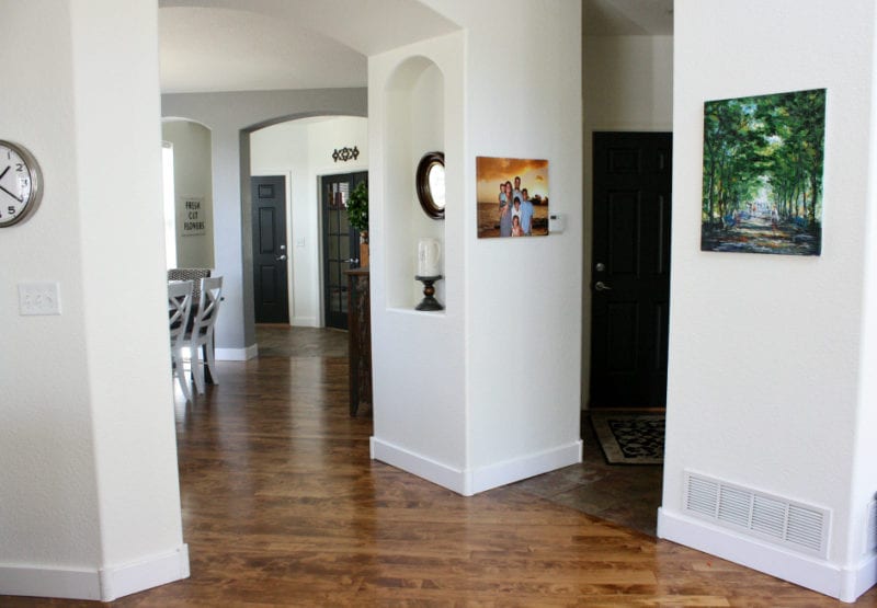 an open concept space with white walls and black interior doors with white trim
