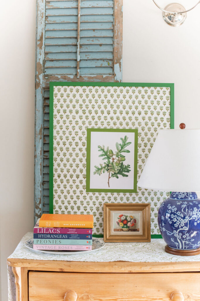 close up of green block print art and blue floral lamp