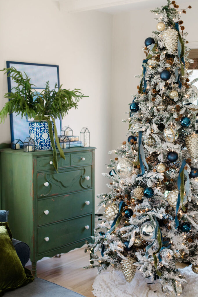 Green dresser near tree with blue ornaments