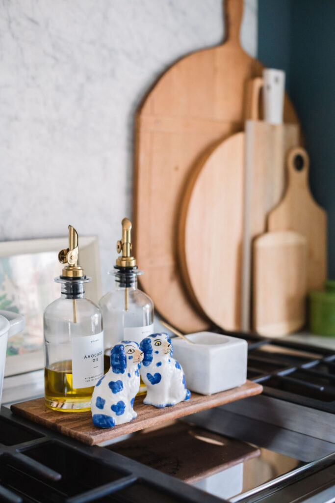 kitchen dog slat and pepper shakers, olive oil bottles and cutting boards