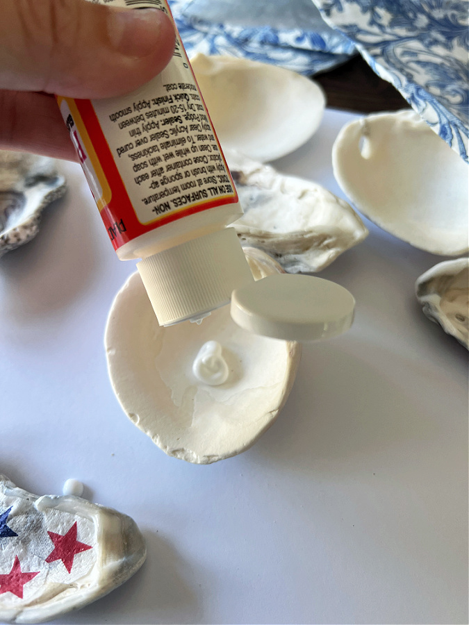 applying the mod podge to the shells