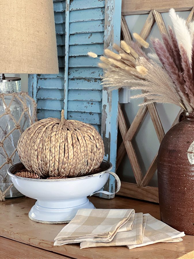 rattan pumpkin in white pedestal bowl