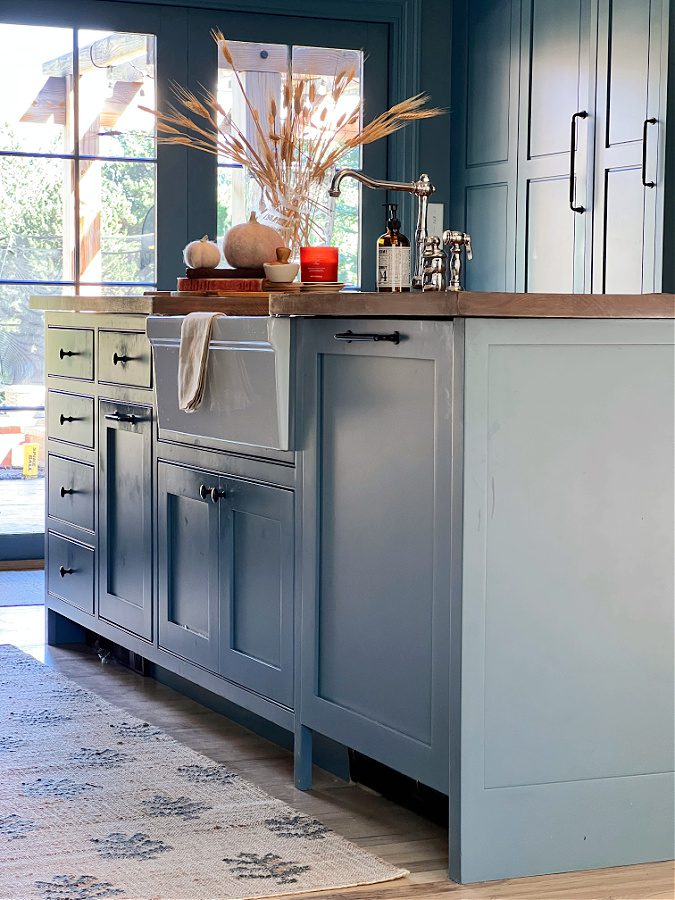 Kitchen sink with blue cabinets