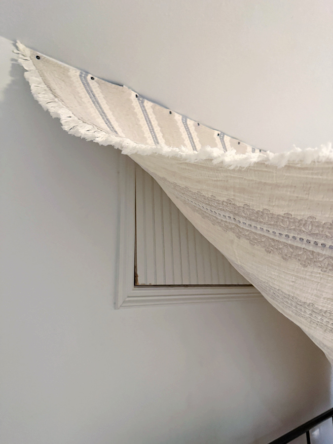 striped neutral blanket hiding crawl space opening