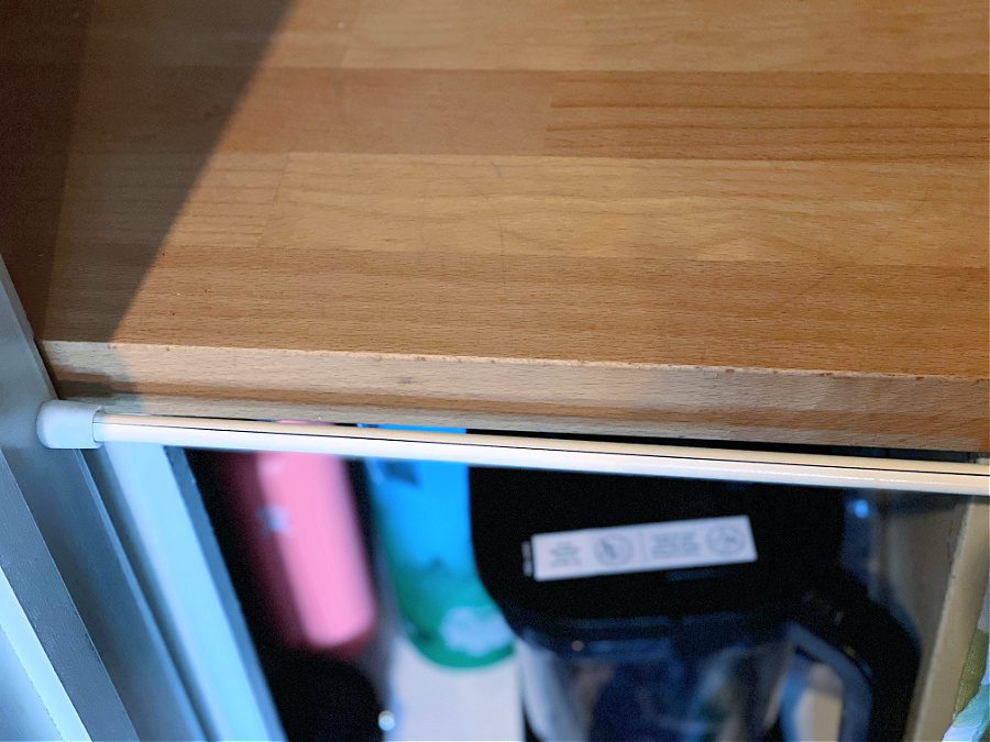 tension rod in pantry with butcher block counters