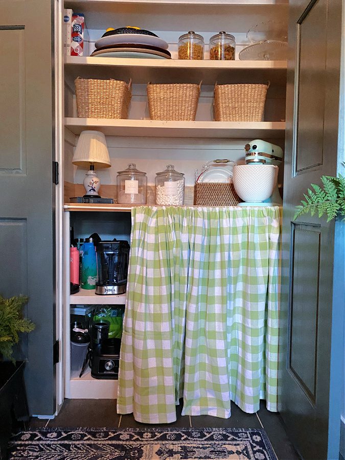 No sew pantry curtain hiding open shelving.