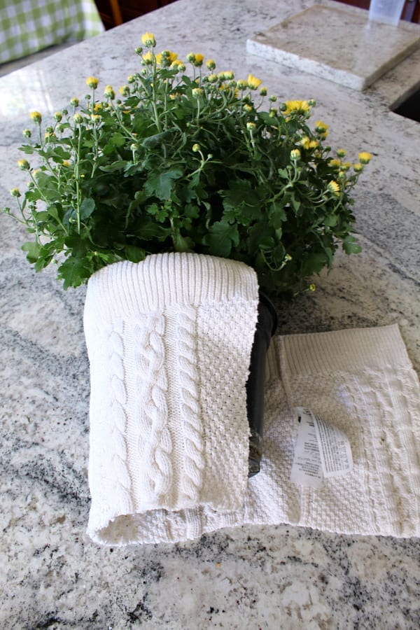 Using pieces of an old sweater to cover up your ugly flwer containers is an easy Fall DIY!