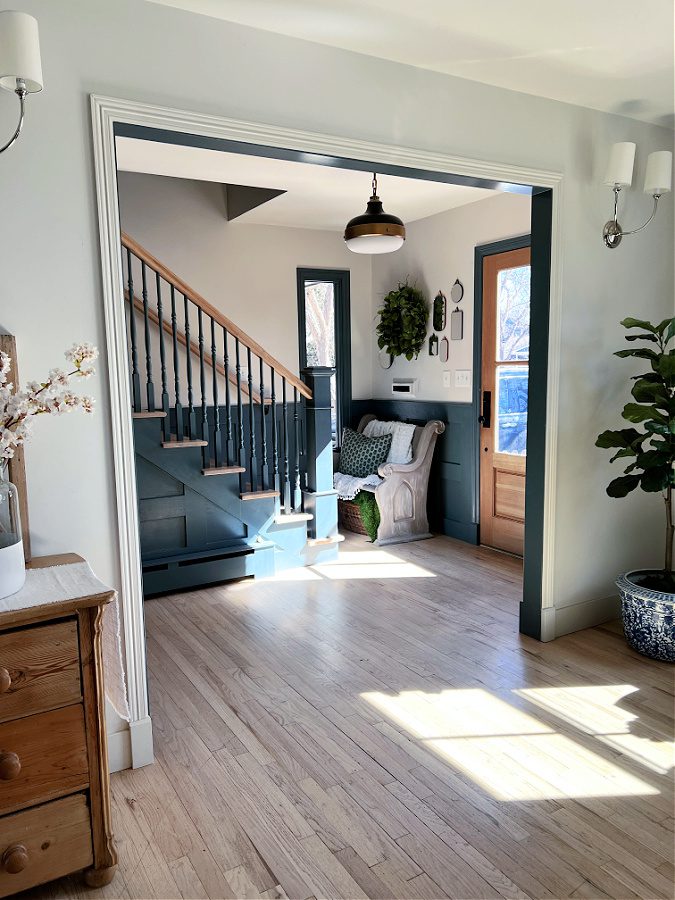 Open entry with peek at front door, stairwell and light.